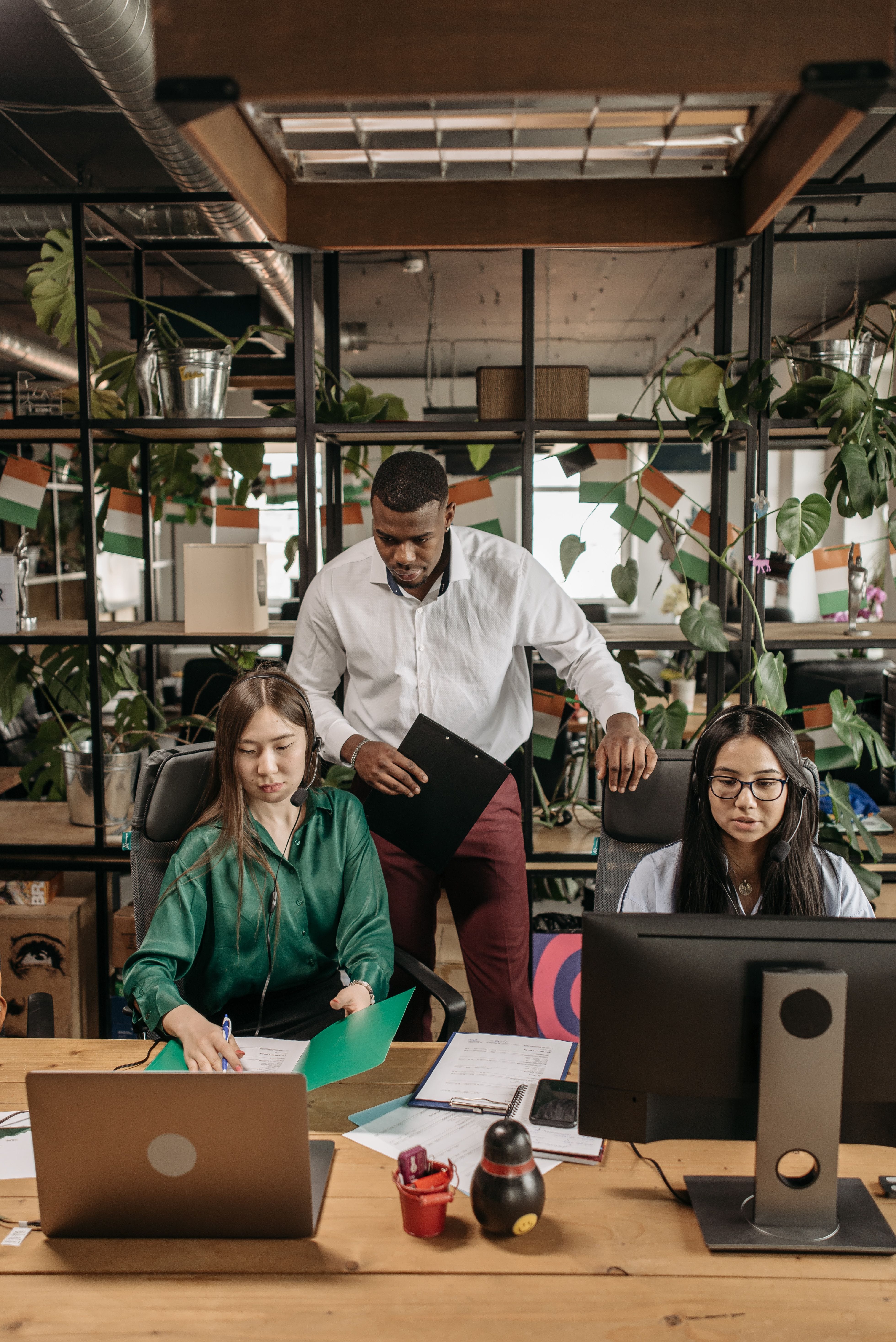 Team members collaborating at computer workstations